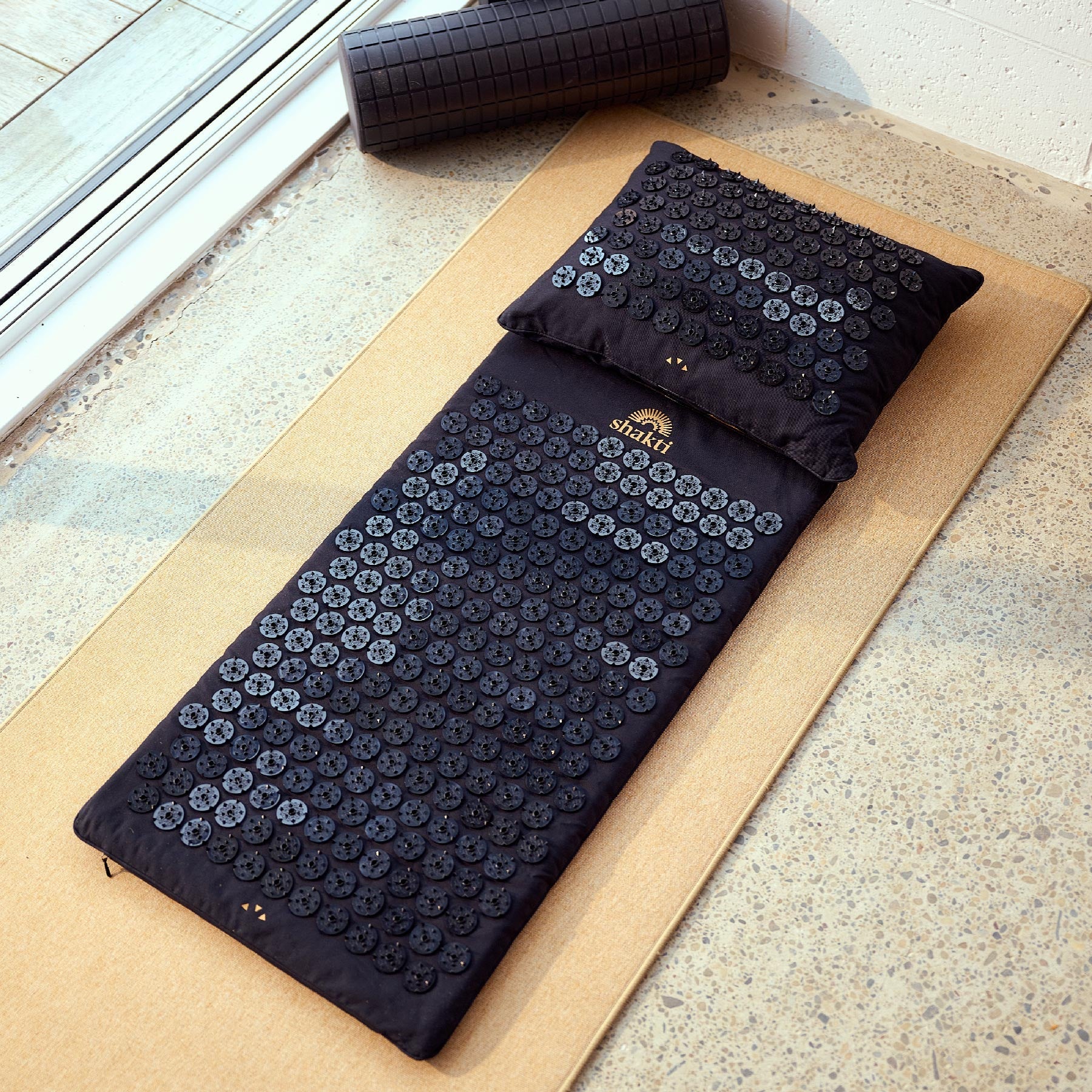 Acupressure mat and pillow set on a Yoga Mat surface with 'Shakti' branding.