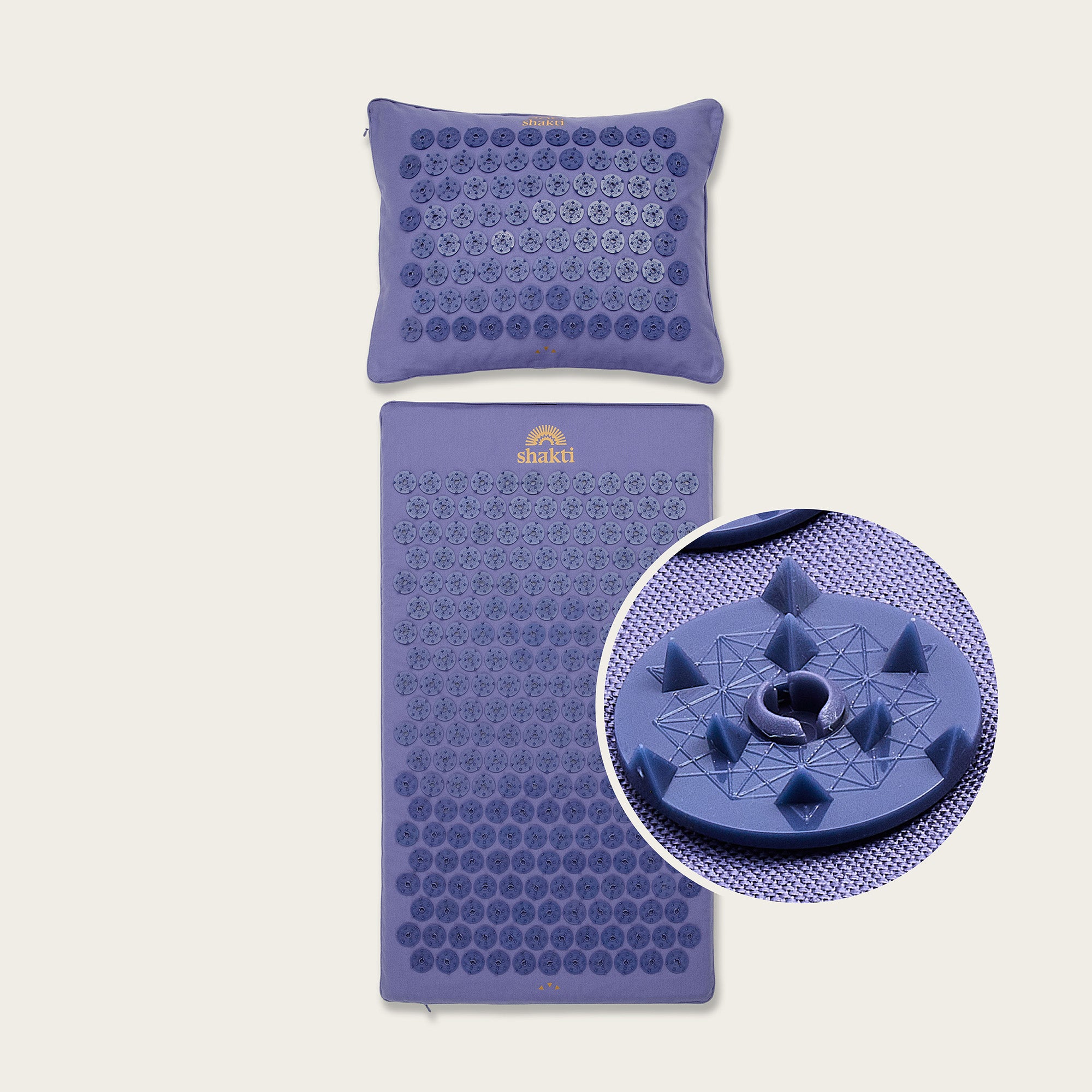 Purple acupressure mat and pillow set with a close-up of the mat's design on a beige background.